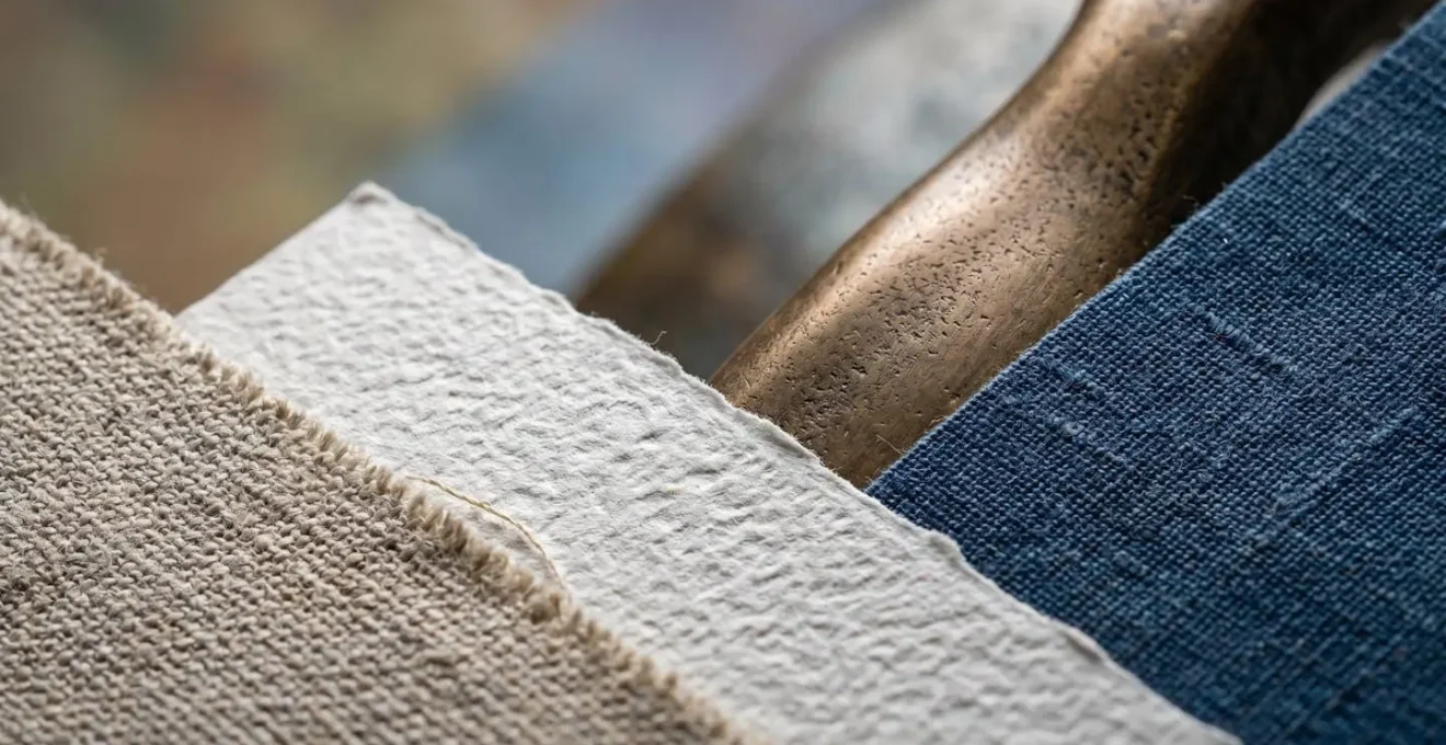 Macro close-up of art portfolio documents showing investment balance between emerging and blue-chip artists